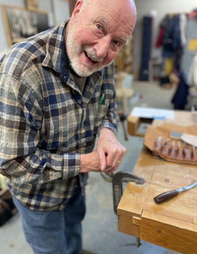 Member using a clamp to hold a spoon.